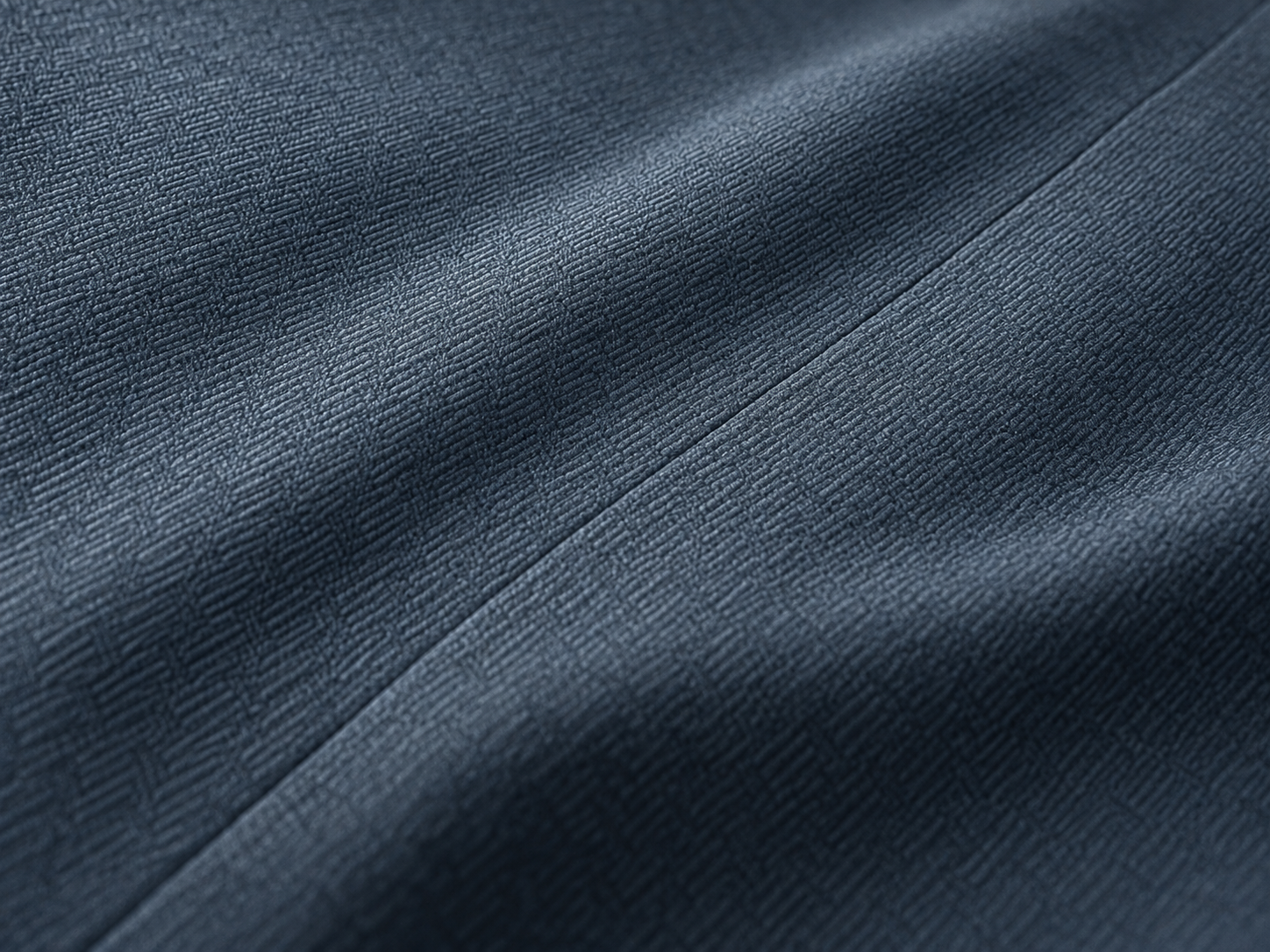 Conceptual close-up of a fine bonded join in blue-grey fabric
